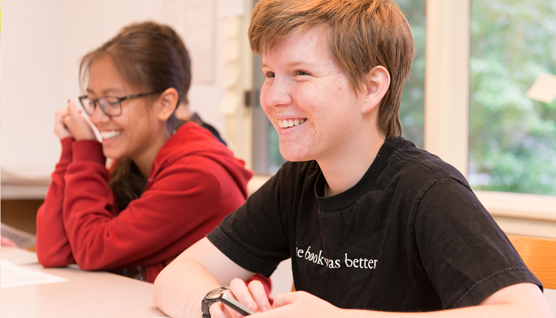 Smiling student wearing "The book was better" t-shirt