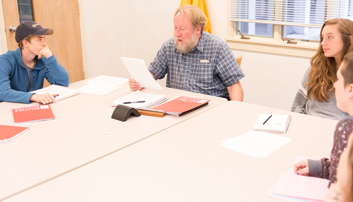 Professor reading to students in class