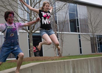 Students jumping off a wall