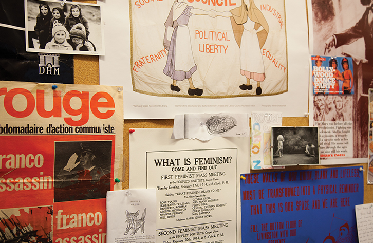 A bulletin board covered in posters and ads.